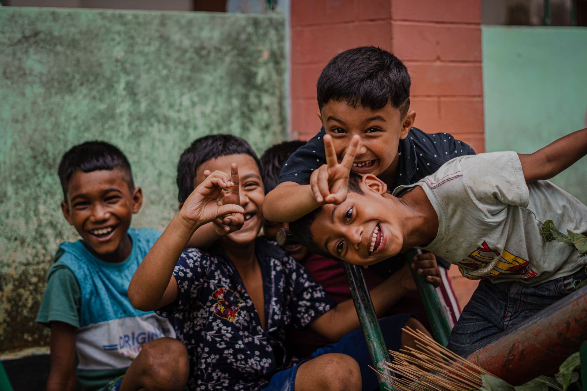 Children from the community smiling and playing together